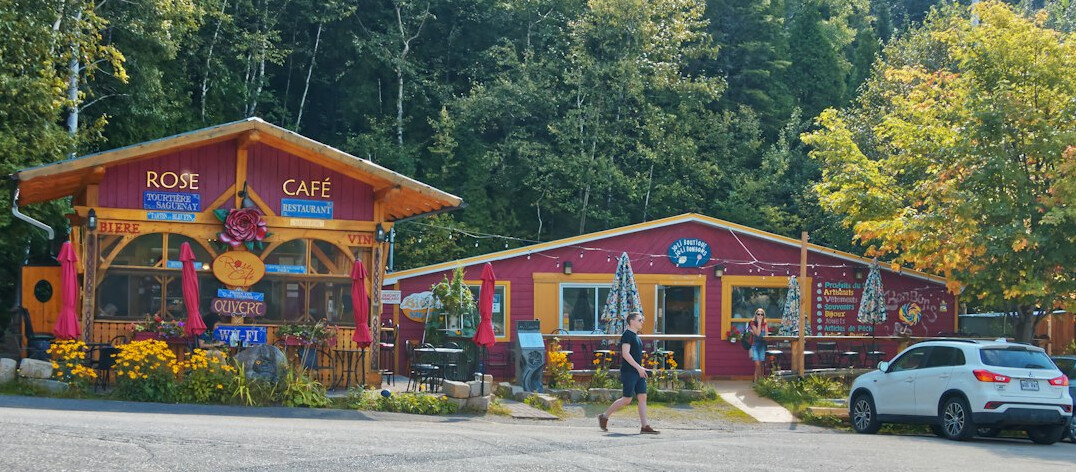 Two friends laughing together in a cozy Canadian café